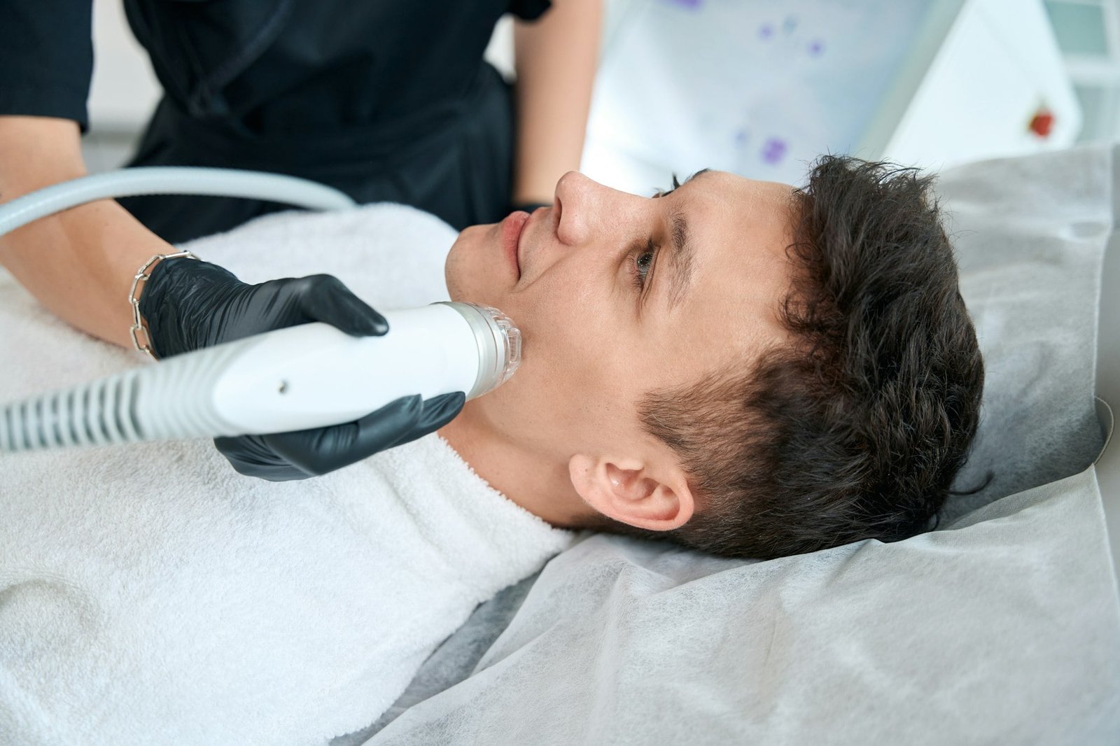 Dermatologist doing facial skin rejuvenation procedure for male